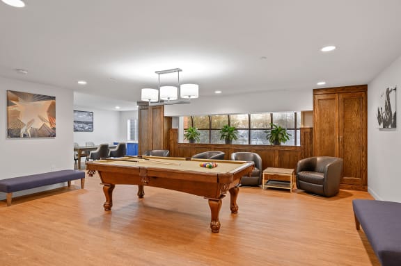 a game room with a pool table and chairs at The Valley, Cincinnati, Ohio