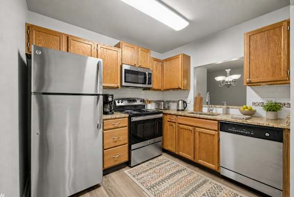 A kitchen with wooden cabinets and stainless steel appliances.