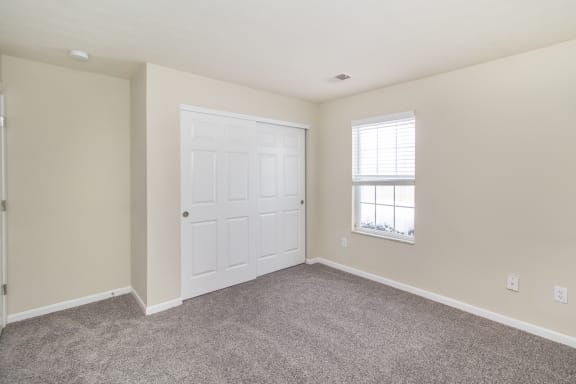 Empty room with a white door and a window