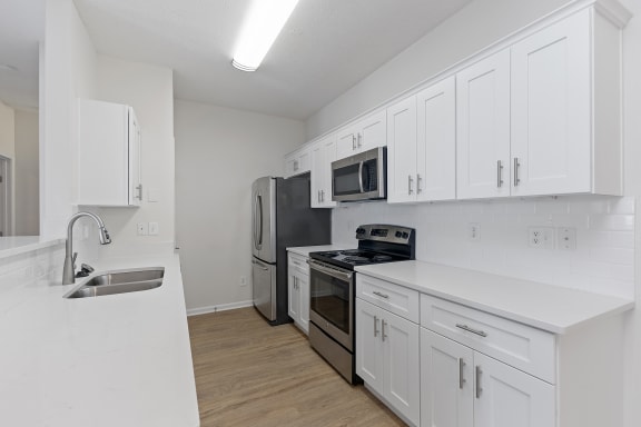 a white kitchen with white cabinets and a sink at Four Bridges, Liberty Township, 45044-8380