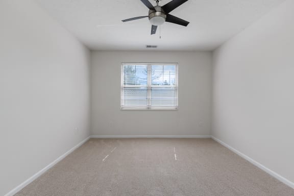 an empty room with a ceiling fan and a window at Four Bridges, Liberty Township, OH, 45044-8380