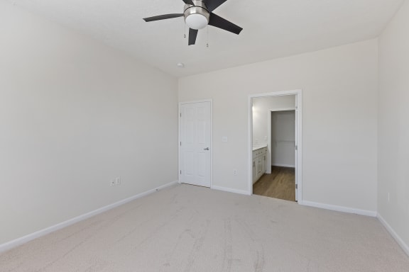 an empty living room with a ceiling fan at Four Bridges, Liberty Township, OH