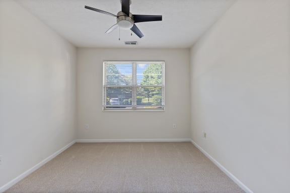 an empty room with a ceiling fan and a window at Four Bridges, Liberty Township, OH, 45044-8380