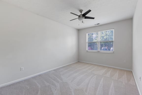 an empty living room with a ceiling fan and a window at Four Bridges, Liberty Township, 45044-8380