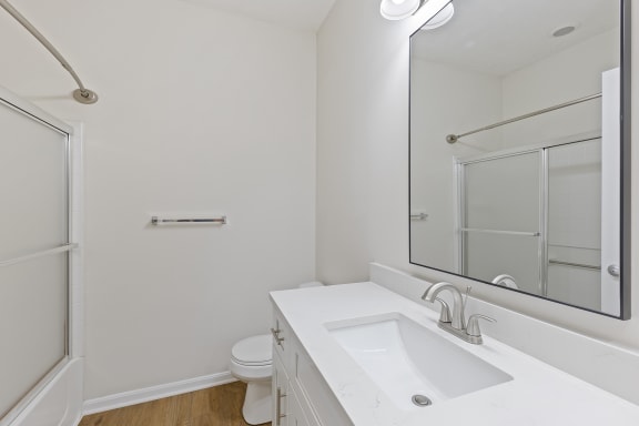 a bathroom with a sink and a mirror and a shower at Four Bridges, Liberty Township