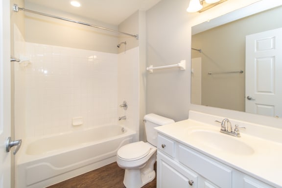 Bathroom with a sink toilet and a tub