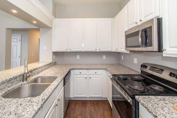 Kitchen with white cabinets and granite counter tops
