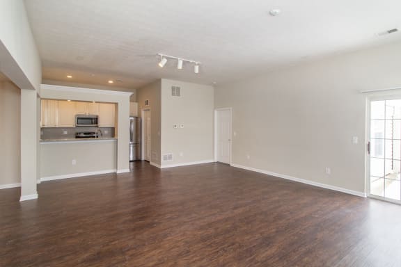 Living room with wood flooring and a kitchen