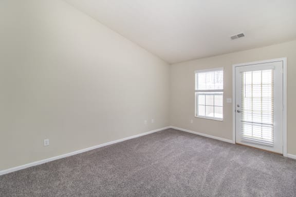 Room with carpet and a door and window