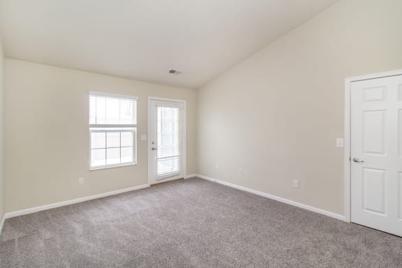 Living room with carpet and a white door