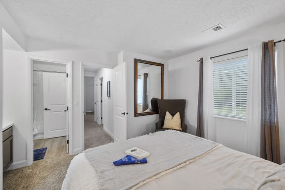 Bedroom with a large bed and a mirror on the wall