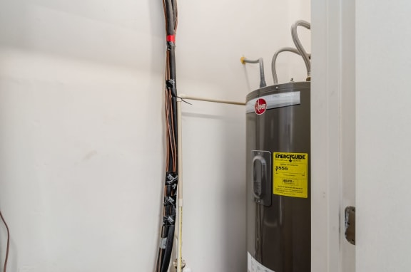 a water heater in the corner of a room