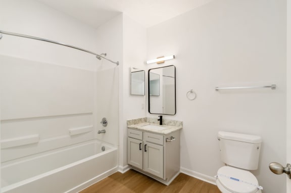 a bathroom with a toilet sink and a bath tub