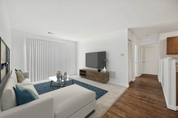 A modern living room with a white sofa and a television.