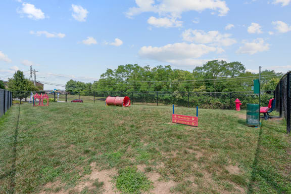 a fenced in dog park with agility courses at The Woodridge Collection, Fairfield