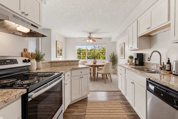 A modern kitchen with a dining table and chairs.