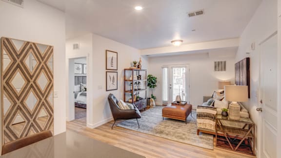 A living room with a brown chair and a brown rug.
