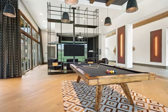 Clubroom with pool table at Windsor Lakeyard District, an apartment community in North Dallas