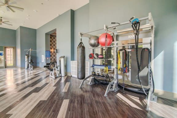 Fitness center with weights and other equipment at Windsor Lakeyard District, an apartment community in North Dallas