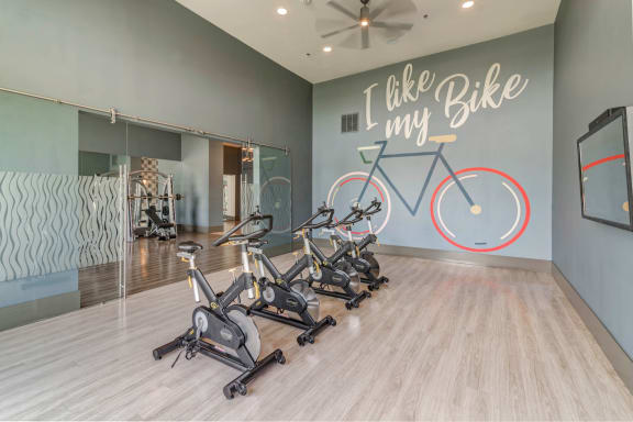 Fitness studio with exercise bikes at Windsor Lakeyard District, an apartment community in North Dallas
