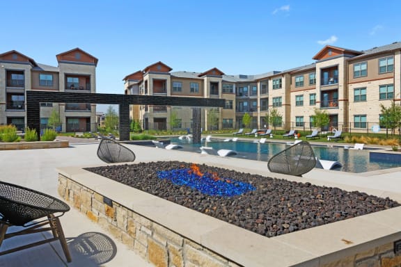 Resort style pool with seating at Windsor Lakeyard District, an apartment community in North Dallas