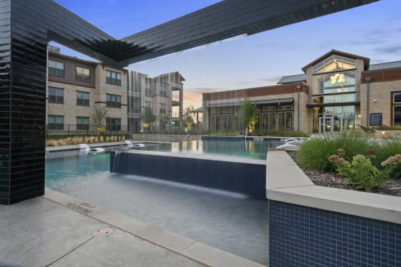 Poolside seating at Windsor Lakeyard District, an apartment community in North Dallas