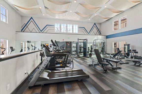 Gym with treadmills and other exercise equipment in a building with large windows at Windsor Westminster, Westminster, Colorado