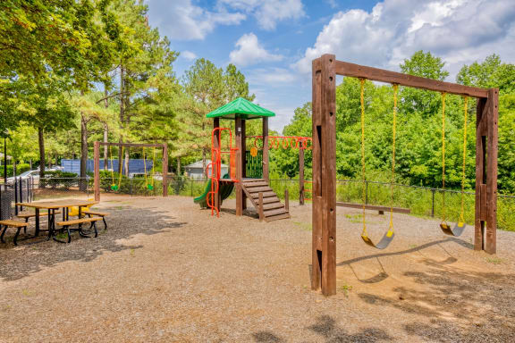 a playground with a swing set and monkey bars