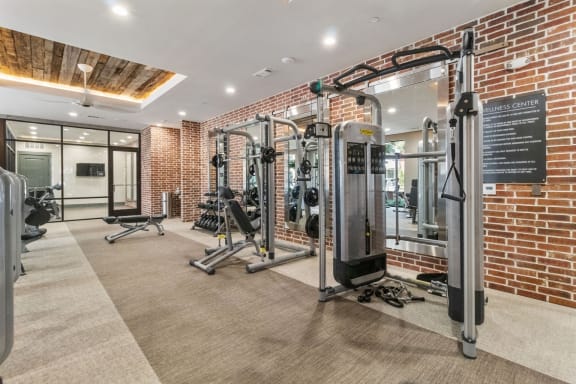 the gym at the district at highland village apartments