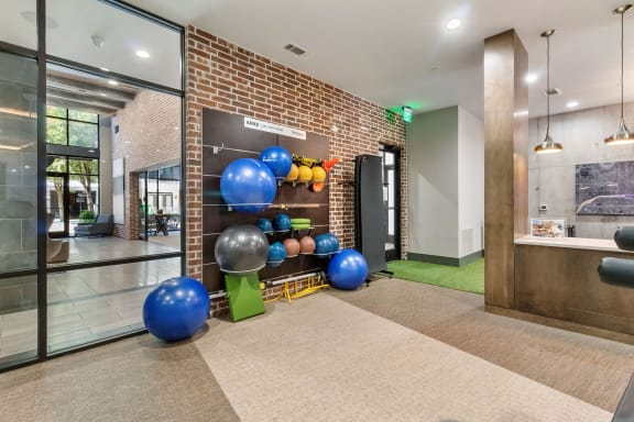 the preserve at ballantyne commons fitness room with weights and balls on a shelf
