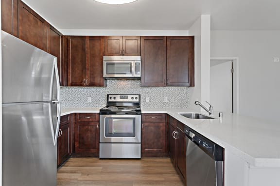 Kitchen with stainless steel appliances at Allegro at Jack London Square in Oakland, CA