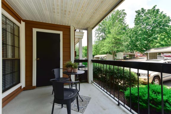 Windsor Oak Creek - apartment balcony with two chairs and a table in Fairfax VA