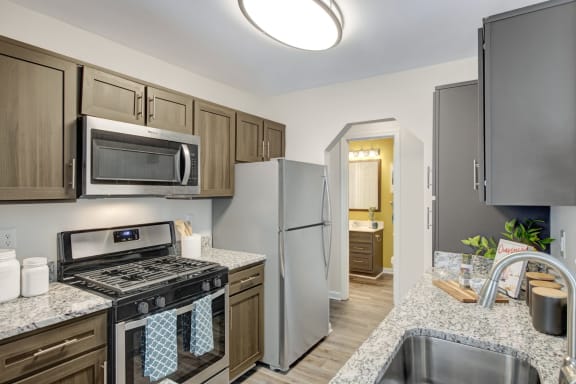 Kitchen with granite countertops and stainless steel appliances at Windsor Kingstowne in Alexandria VA