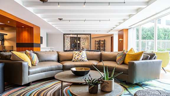 a living room filled with furniture and a large window