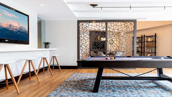 a games room with a ping pong table and a fireplace