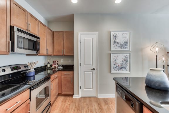 a kitchen with a stove top oven and a microwave