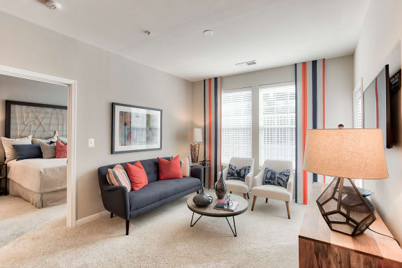 a living room filled with furniture and a large window