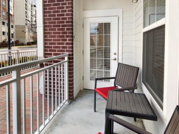 a balcony with a wooden bench and a door