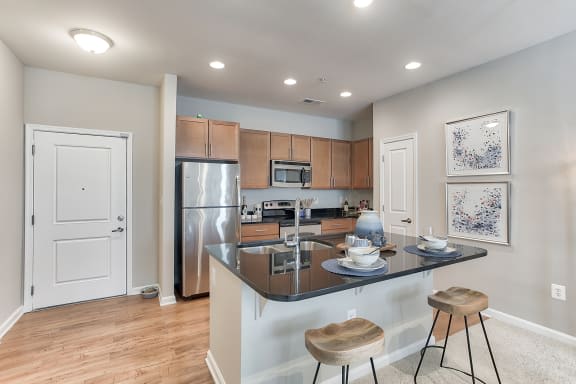 a kitchen with an island and two stools