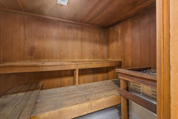 A wooden room with benches and a table.