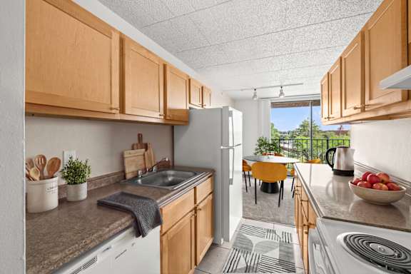 A kitchen with wooden cabinets and a white refrigerator.