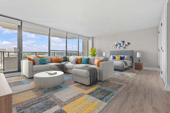 A modern living room with a large grey sofa and a coffee table.
