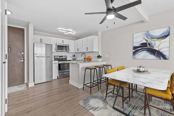 A modern kitchen with a dining table and chairs.