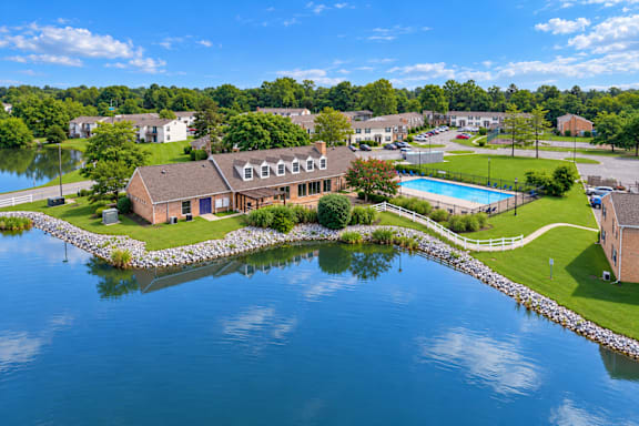 A house is surrounded by water and has a pool.