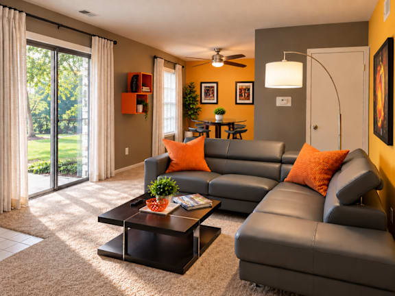 A living room with a grey couch and a coffee table.