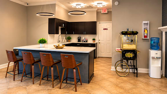 A kitchen with a bar area and a bicycle on display.
