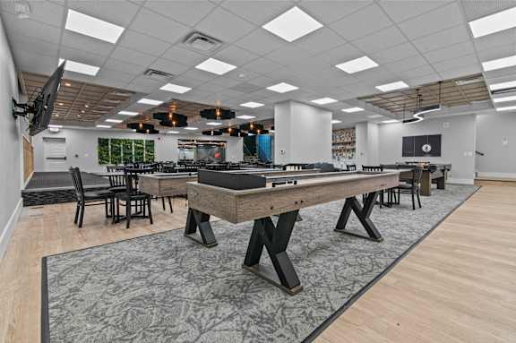 A room with a large table and chairs.