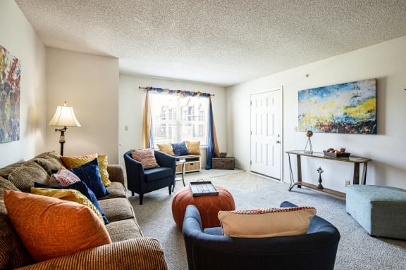 Living room in a two-bedroom model unit at The Lakes, with ample natural light.