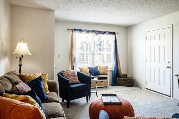 Living room in a two-bedroom model unit at The Lakes, with ample natural light."