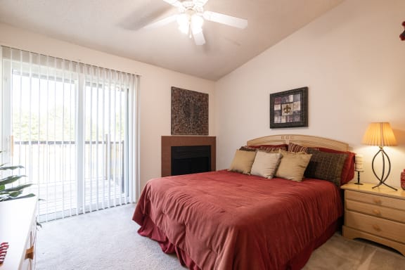 Bedroom fireplace in a one-bedroom townhome model unit at The Lakes.